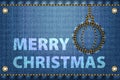 Merry Christmas greetings on blue jeans background Royalty Free Stock Photo