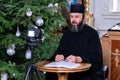 . Merry Christmas greetings. Priest online. An Orthodox priest is recording a video for his blog. Preaching during a pandemic