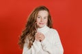 Merry Christmas girl in white sweater on bright red vivid color background Royalty Free Stock Photo