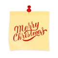 Merry Christmas hand written on yellow sticky note attached with red pin. Realistic sticker and pushpin isolated on white. Royalty Free Stock Photo