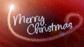 Merry Christmas handwritten inscription with a magical effect and scattered glitter. Festive background