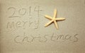 Merry Christmas 2014 handwritten in sand