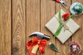 Merry Christmas Handy Tools Christmas Gift concept. Hammer, pliers, gift box and Christmas ornament decorations on wood