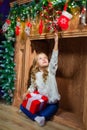 Merry Christmas happy girl with magic gift at home near Christma Royalty Free Stock Photo