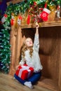 Merry Christmas happy girl with magic gift at home near Christma Royalty Free Stock Photo