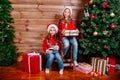 Merry Christmas and Happy Holiday. Two cute little child girls with present gift boxes near tree indoor Royalty Free Stock Photo