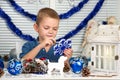 Merry Christmas and happy holidays!A boy painting a snowflake. Child creates decorations for Christmas interior.