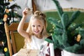 Merry Christmas and Happy Holidays. Cheerful cute child girl opening a Christmas present. Royalty Free Stock Photo