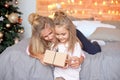 Merry Christmas and Happy Holidays.Cheerful cute children opening gifts. Kids having fun near tree in the morning