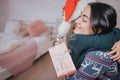 Merry Christmas and Happy Holidays Cheerful mom and her cute daughter girl exchanging gifts. Parent and little child Royalty Free Stock Photo