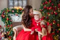 Merry Christmas and Happy Holidays Cheerful mom and her cute daughter girl exchanging gifts. Parent and little child having fun Royalty Free Stock Photo