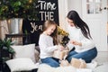 Merry Christmas and Happy Holidays. Cheerful mom and her cute daughter girl exchanging gifts. Parent and little child Royalty Free Stock Photo