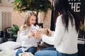 Merry Christmas and Happy Holidays. Cheerful mom and her cute daughter girl opening a Christmas present. Parent and Royalty Free Stock Photo