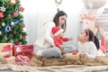 Merry Christmas and Happy Holidays! Cheerful mom and her cute daughters playing and have fun together Royalty Free Stock Photo