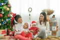 Merry Christmas and Happy Holidays! Cheerful mom and her cute daughters playing and have fun together Royalty Free Stock Photo