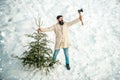 Merry Christmas and Happy Holidays. Christmas tree cut. Man lumberman with Christmas tree in winter park. Bearded Man