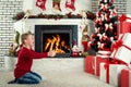 Merry Christmas and Happy Holidays!Cute child found many gifts under the Christmas tree. Royalty Free Stock Photo