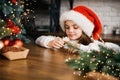 Merry Christmas and Happy Holidays. Cute child girl eating ginger cookies. Royalty Free Stock Photo