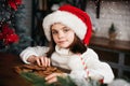 Merry Christmas and Happy Holidays. Cute child girl eating ginger cookies. Royalty Free Stock Photo