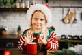 Merry Christmas and Happy Holidays. Cute child girl eating ginger cookies. Royalty Free Stock Photo