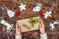 Merry Christmas and Happy Holidays! Preparation of New Year`s gifts.Top view. A wooden background with Christmas decorations.