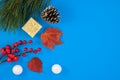 Merry Christmas and Happy Holidays greeting card, frame, banner, pine cone and decorative snowballs on blue background, top view. Royalty Free Stock Photo