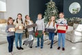 Merry Christmas. Group of children in cozy room after exchanging Xmas presents at fun party Royalty Free Stock Photo