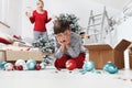 Merry Christmas and Happy Holidays! Mom and son decorate the Christmas tree indoors. accidentally the child breaks the balls, Royalty Free Stock Photo