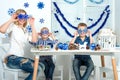 Merry Christmas and happy holidays!Mother and two sons having fun while creating Christmas decor. Royalty Free Stock Photo