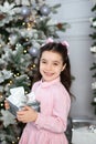 Merry Christmas and happy holidays! New Year 2020. Happy little girl with christmas present at home. kid holds gift box near Chris Royalty Free Stock Photo