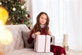 Merry Christmas and happy holidays! New Year 2020. Happy little girl with christmas present at home. kid holds gift box near Chris Royalty Free Stock Photo