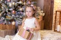 Merry Christmas and happy holidays! New Year 2020. Happy little girl with christmas present at home. kid holds gift box near Chris Royalty Free Stock Photo