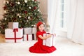 Merry Christmas and happy holidays! New Year 2020. Happy little girl with christmas present at home. kid holds gift box near Chris Royalty Free Stock Photo