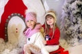 Merry Christmas, happy holidays. New Year. Little girls like to ride sleigh. Children sledges. Street fun for family Christmas. Wi