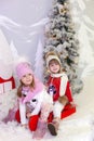 Merry Christmas, happy holidays. New Year. Little girls like to ride sleigh. Children sledges. Street fun for family Christmas. Wi