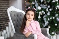 Merry Christmas, happy holidays! New Year 2020. Portrait of little girl with bows on head daydreaming for Christmas near Christmas Royalty Free Stock Photo