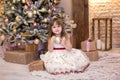 Merry Christmas and happy holidays! New Year 2020. Portrait little girl decorates a Christmas tree in living room with toys. child Royalty Free Stock Photo