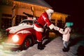 Merry Christmas and happy holidays! Santa Claus giving xmas presents cute little girl. Royalty Free Stock Photo