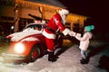 Merry Christmas and happy holidays! Santa Claus giving xmas presents cute little girl. Royalty Free Stock Photo