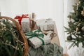 Merry Christmas and Happy holidays! Stylish wrapped christmas gifts, rustic basket with fir branches and modern decorations on Royalty Free Stock Photo