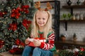 Merry Christmas and Happy Holidays. Surprised cute child girl opening present. Royalty Free Stock Photo