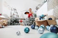 Merry Christmas and Happy Holidays! Woman decorate the Christmas tree indoors