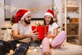 Attractive young couple is celebrating holiday at home together Royalty Free Stock Photo