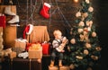 Merry Christmas and Happy New year. Babies. Portrait kid with gift on wooden background. Happy child with christmas gift