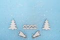 Merry Christmas and Happy New Year banner. Festive poster with a Christmas tree, sledges and snow on a blue background