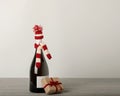 Merry Christmas and a Happy New Year! Bottle of wine in a knitted cap of Santa Claus. Royalty Free Stock Photo