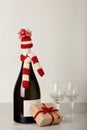 Merry Christmas and a Happy New Year! Bottle of wine in a knitted cap of Santa Claus. Royalty Free Stock Photo