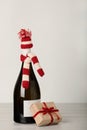 Merry Christmas and a Happy New Year! Bottle of wine in a knitted cap of Santa Claus. Royalty Free Stock Photo