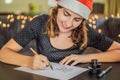 Merry christmas and a happy new year. Calligrapher Young Woman writes phrase on white paper. Inscribing ornamental Royalty Free Stock Photo