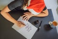 Merry christmas and a happy new year. Calligrapher Young Woman writes phrase on white paper. Inscribing ornamental Royalty Free Stock Photo